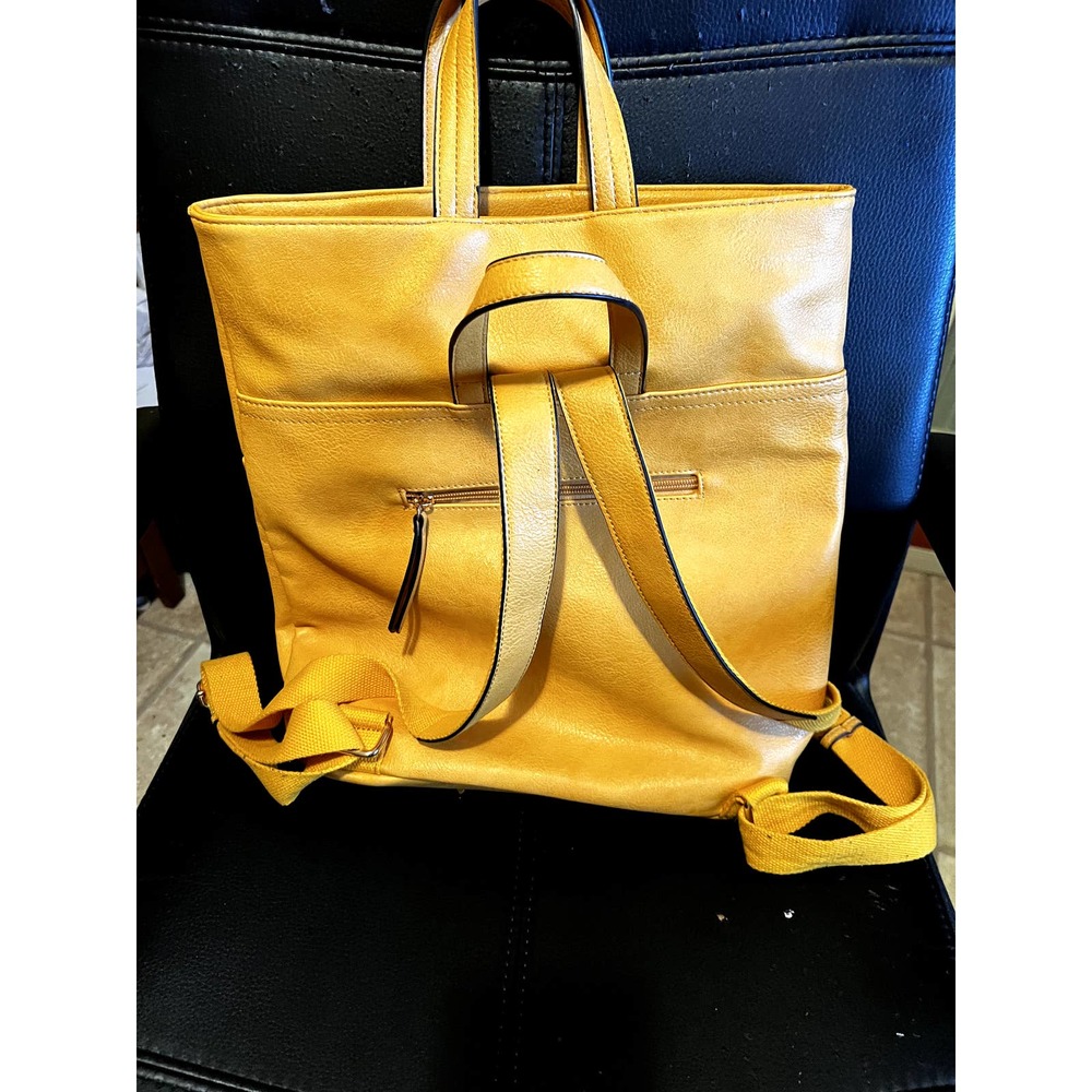 Leather yellow bucket Backpack with Handles and zippered closure.